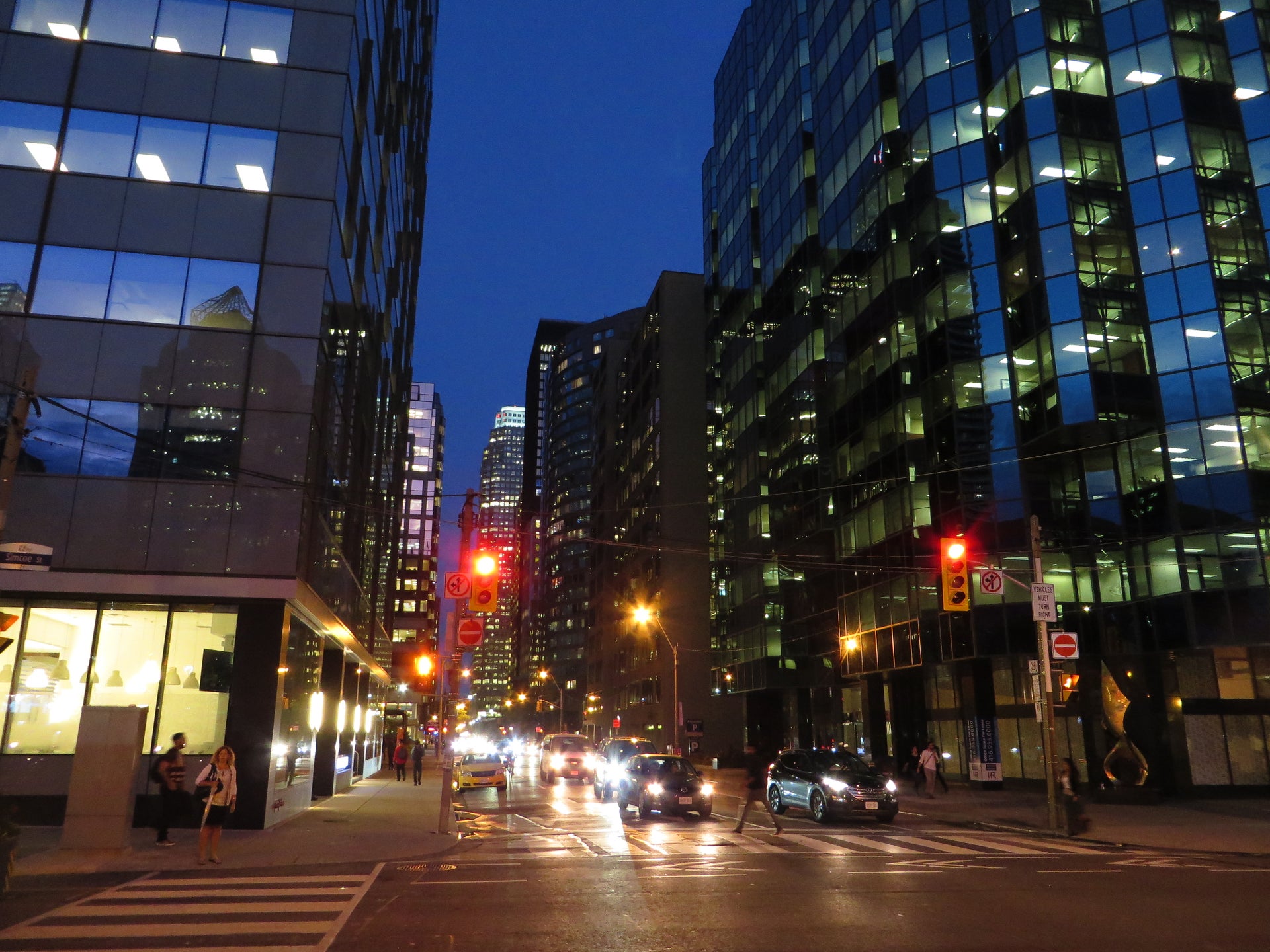 Toronto financial district at night with glass office towers and city traffic