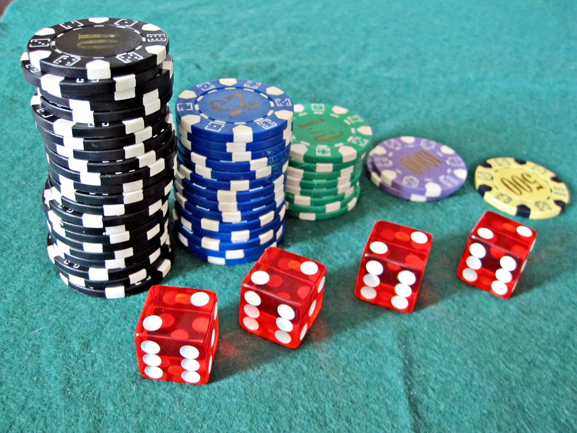 PAGCOR Remits PHP5.67B in Dividends to National Treasury Red dice and stacks of casino chips on a green felt table