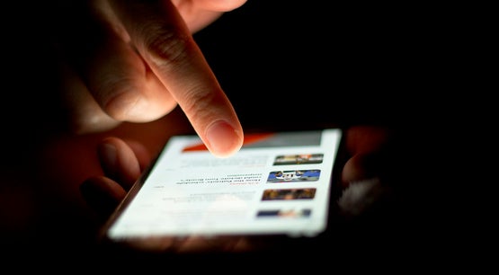 Scrolling on phone.jpg - Wikimedia Commons Someone Scrolling on Their Phone