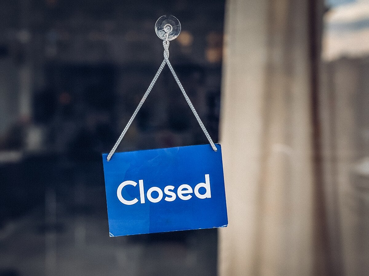Close-up of a closed sign hanging on a store door A Closed Sign