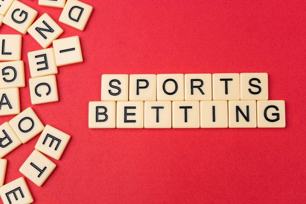 Sports betting in scrabble tiles An image of sports betting written in scrabble tiles