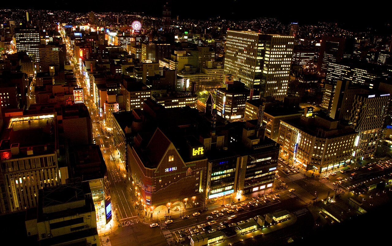 Night view of Sapporo city skyline, Hokkaido, Japan, with illuminated buildings and streets