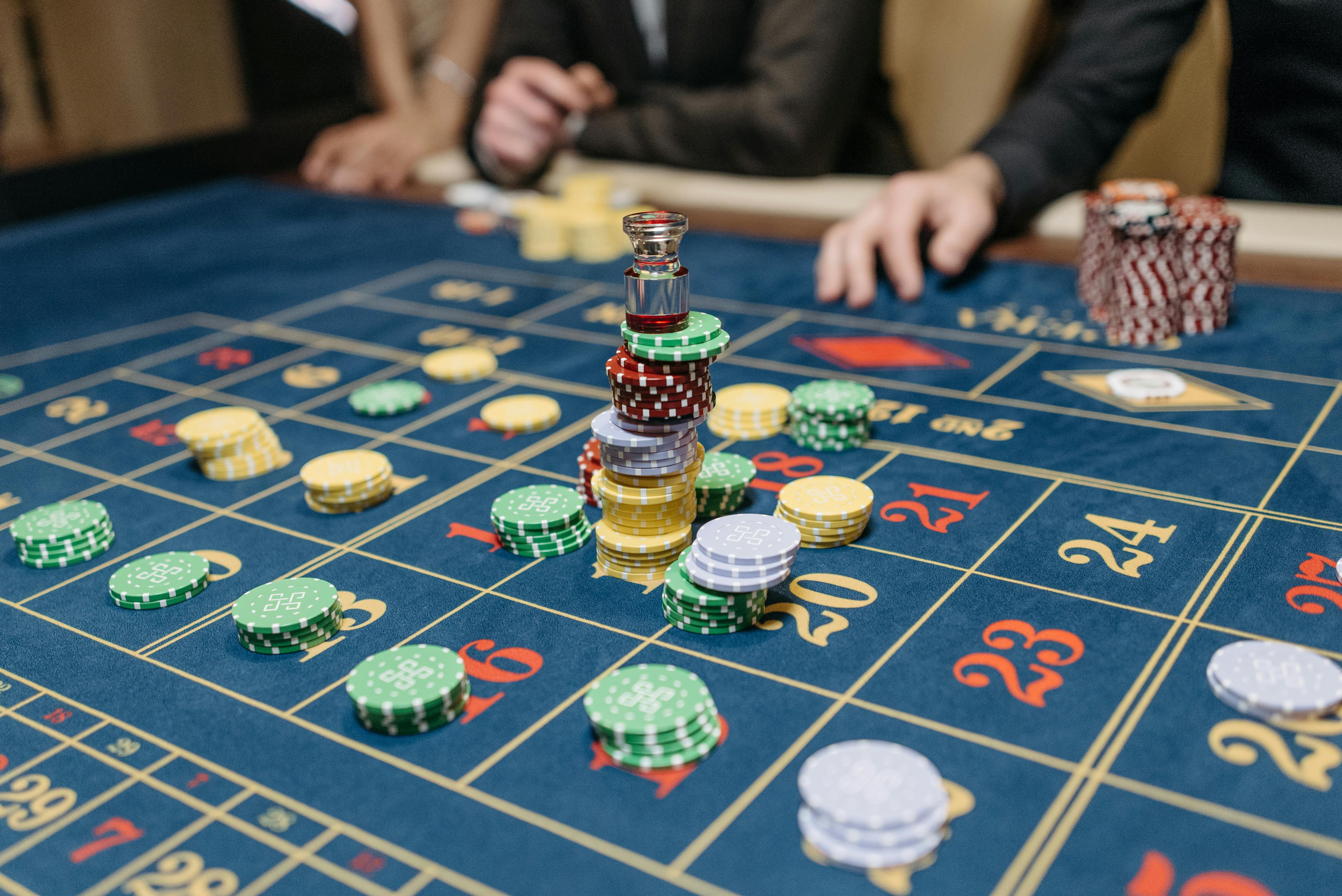 Roulette table with stacked casino chips and active bets during gameplay