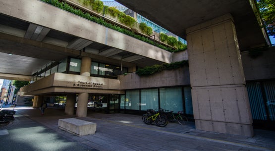 British Columbia Court of Appeal & Supreme Court Building in Vancouver Concrete exterior of the British Columbia Court of Appeal and Supreme Court building in Vancouver, featuring brutalist architecture with layered walkways, greenery, and bicycles at street level