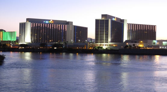 Aquarius Casino Resort lit up at dusk along the Colorado River in Laughlin, Nevada