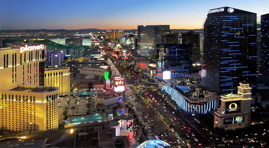 Aerial view of the Las Vegas Strip at dusk showing casino resorts along South Las Vegas Boulevard