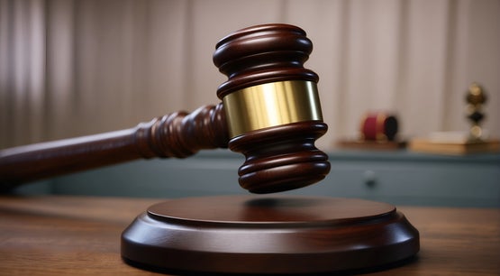 Thai Court Jails Ex-Senator's Son for 132 Years in Gambling Case A wooden judge's gavel with a gold band striking a sound block on a courtroom desk