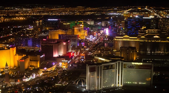 Aerial night view of the Las Vegas Strip with illuminated casino hotels and city lights