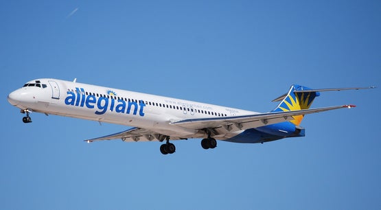 Allegiant Air aircraft on approach to landing against a clear blue sky