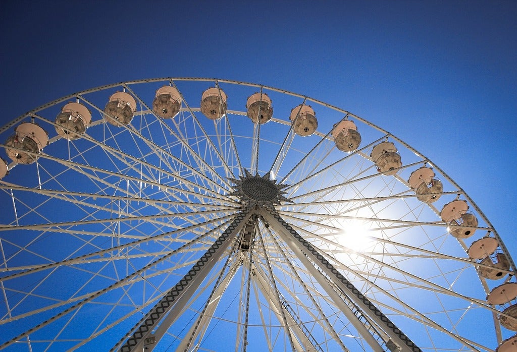Las Vegas Strip Resort Approved on Former SkyVue Site Ferris wheel against a blue sky with the sun visible through its spokes