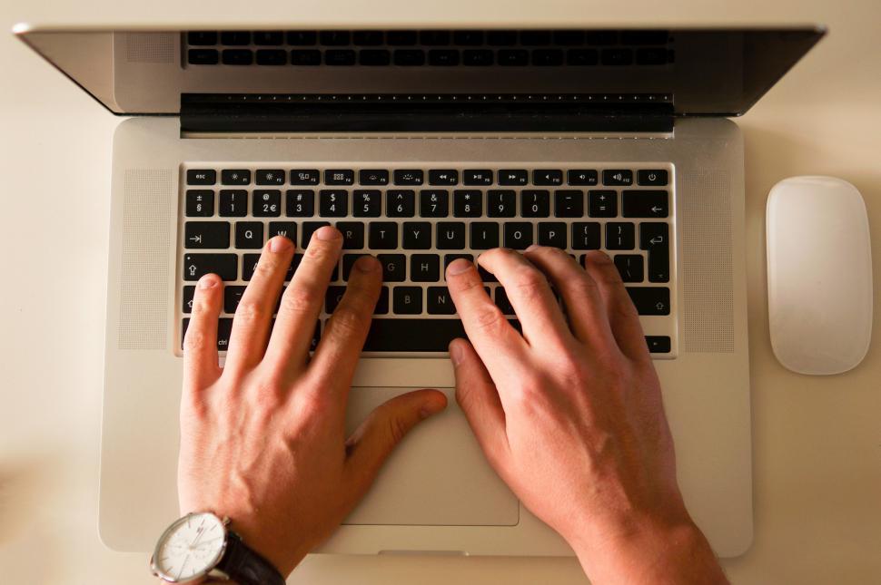 Alberta Online Casino Market Hits 3.2M Geolocation Checks Person typing on a laptop, representing online casino and geolocation activity in Alberta