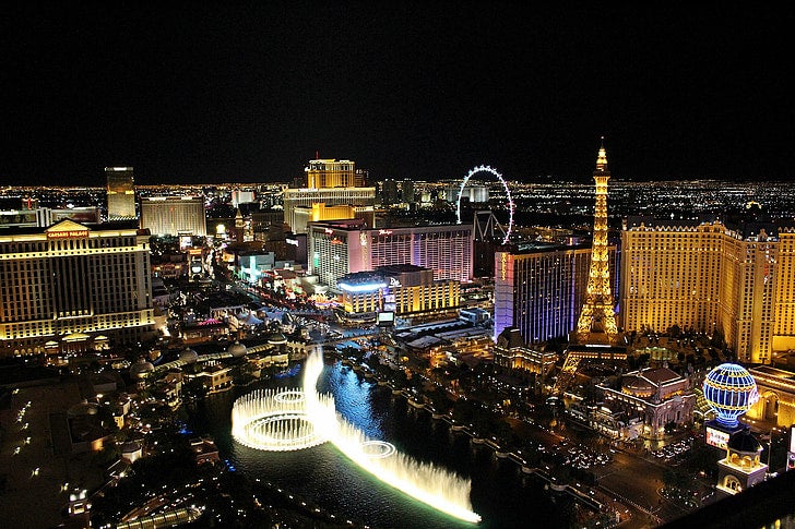 Vegas 5-Day Sale: 180+ Deals as Las Vegas Tourism Steadies Las Vegas Strip at night with the Bellagio fountains, Caesars Palace, the Paris Las Vegas Eiffel Tower and the High Roller