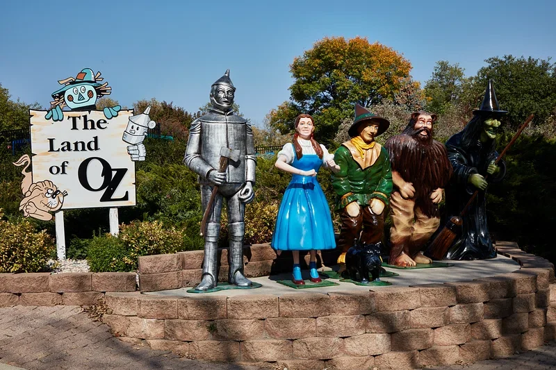 Wizard of Oz at Sphere Marks First Anniversary Event Statues of Dorothy, the Tin Man, Scarecrow, Cowardly Lion, and Wicked Witch at The Land of Oz display