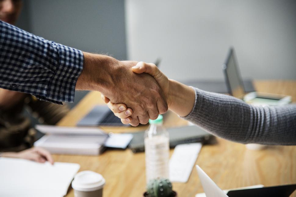 Two people shaking hands close view - freerangestock.com Two People Shaking Hands in Agreement
