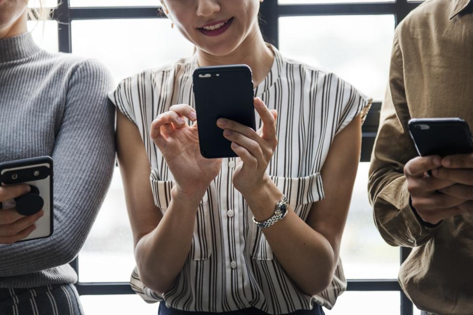 bet365 Approved for Alberta's iGaming Market Launch Group of women looking at their mobile phones