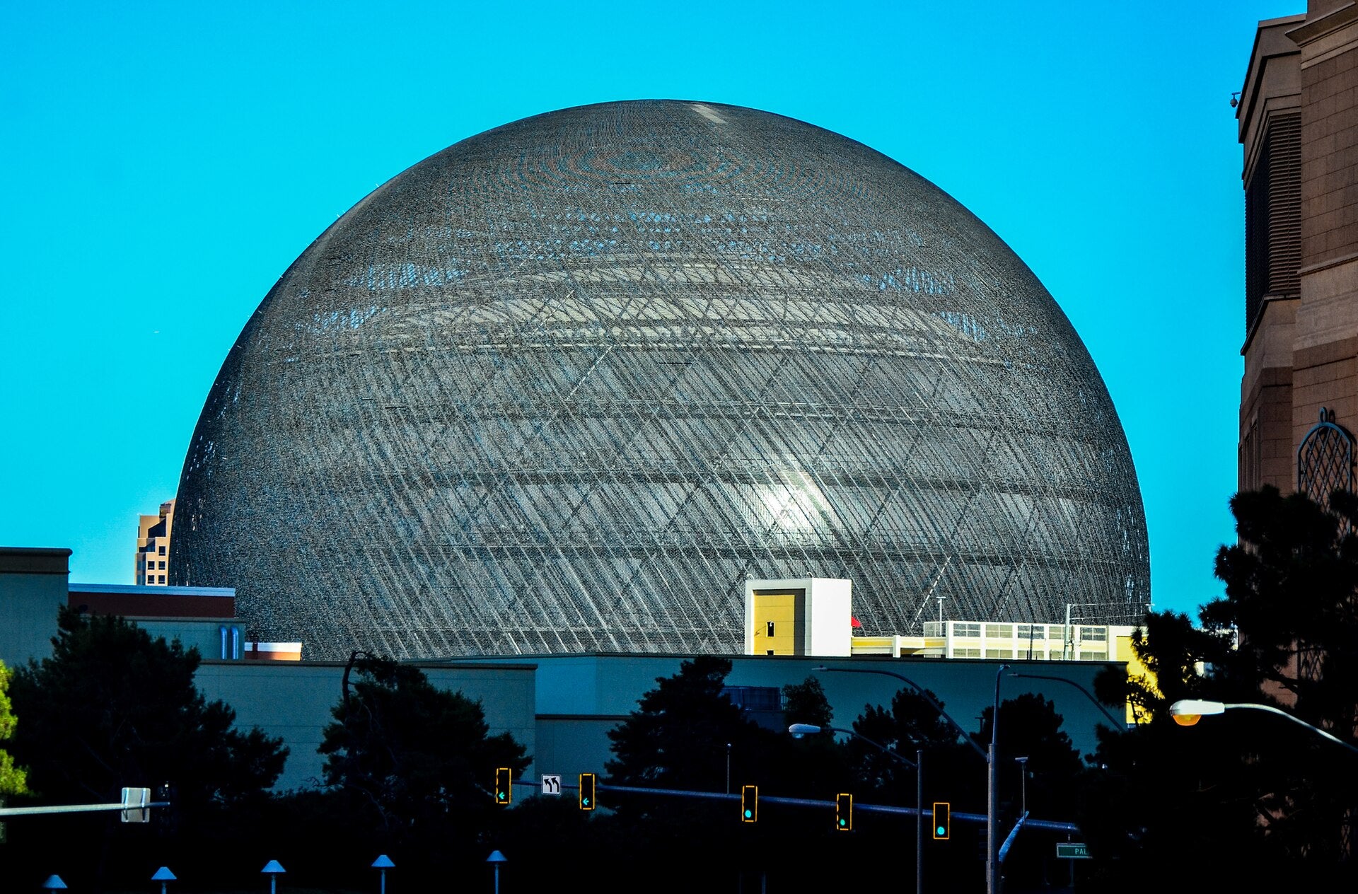 Exterior view of the Sphere entertainment venue in Las Vegas against a clear blue sky